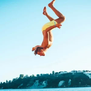 Guest doing a backflip dive at Boat Party Malta.