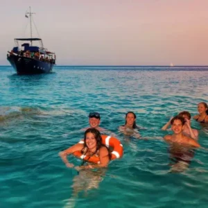 Group swimming during the swim stop at Boat Party Malta.
