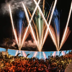 Fireworks exploding over a high-energy pool party at Cafe Del Mar Malta.