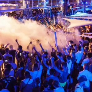 A packed pool party at Cafe Del Mar Malta, with people dancing in the water.