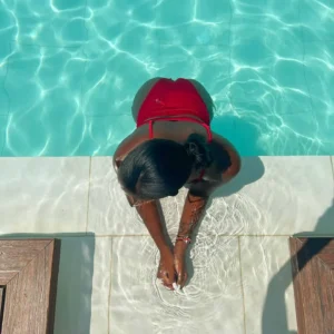 Woman in red swimsuit by the pool at Flo Skypool Malta.