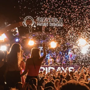 A huge crowd dancing as confetti falls at G7 Fridays, Gianpula Malta.