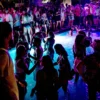 People in swimwear relaxing and partying at The Rooftop, Gianpula Malta.