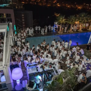 An aerial view of the rooftop White Party at Hugo Hotel Malta, with guests enjoying the vibrant atmosphere and stunning surroundings.