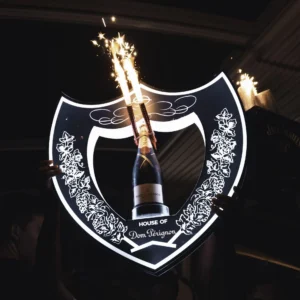 A luxurious Dom Perignon bottle being delivered to the VIP table at Hugo Hotel Malta, highlighting the exclusive service.