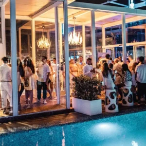 A view of the pool area during the White Party at Hugo Hotel Malta, where guests enjoy the sophisticated setting and vibrant energy.