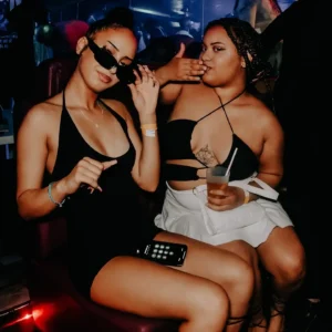 Two young women posing for photos at the Black Out Party at Sky Club Malta