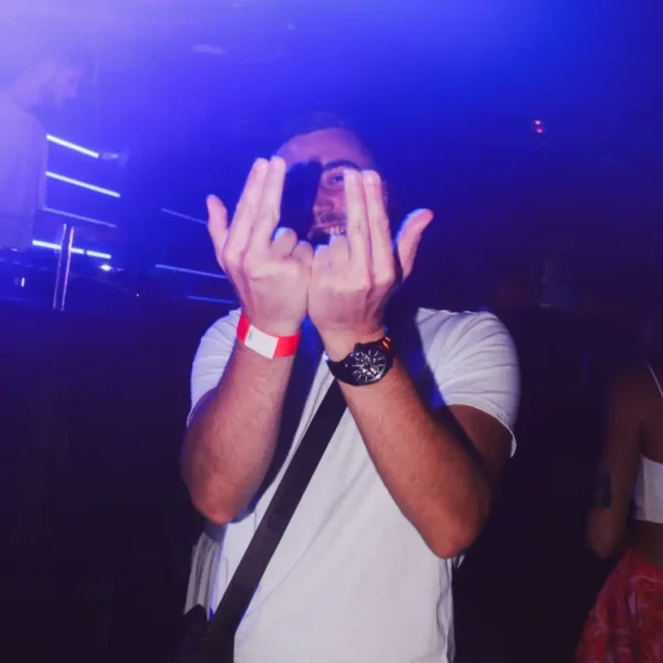 Man making the Jul rap sign at Le Classico French Party at Sky Club Malta.