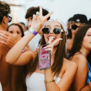 Girl making a peace sign at Toy Room Beach Club Malta.
