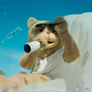 Mascot holding champagne bottle at Toy Room Beach Club Malta.