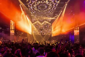 Interior of Toy Room Malta showcasing vibrant light effects over a large crowd.