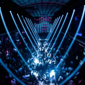 Aerial shot of a large crowd bathed in blue lighting at Toy Room Malta.