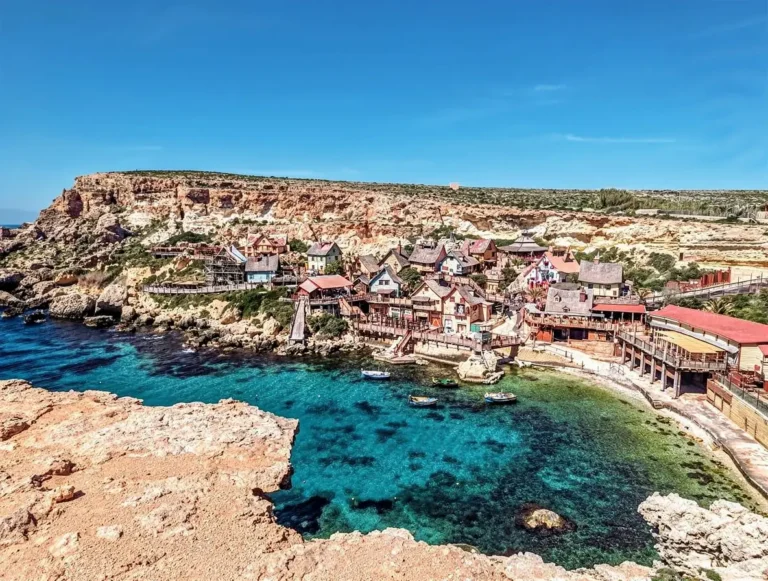 Colourful wooden houses of Popeye Village Malta (Sweethaven Village) at Anchor Bay.