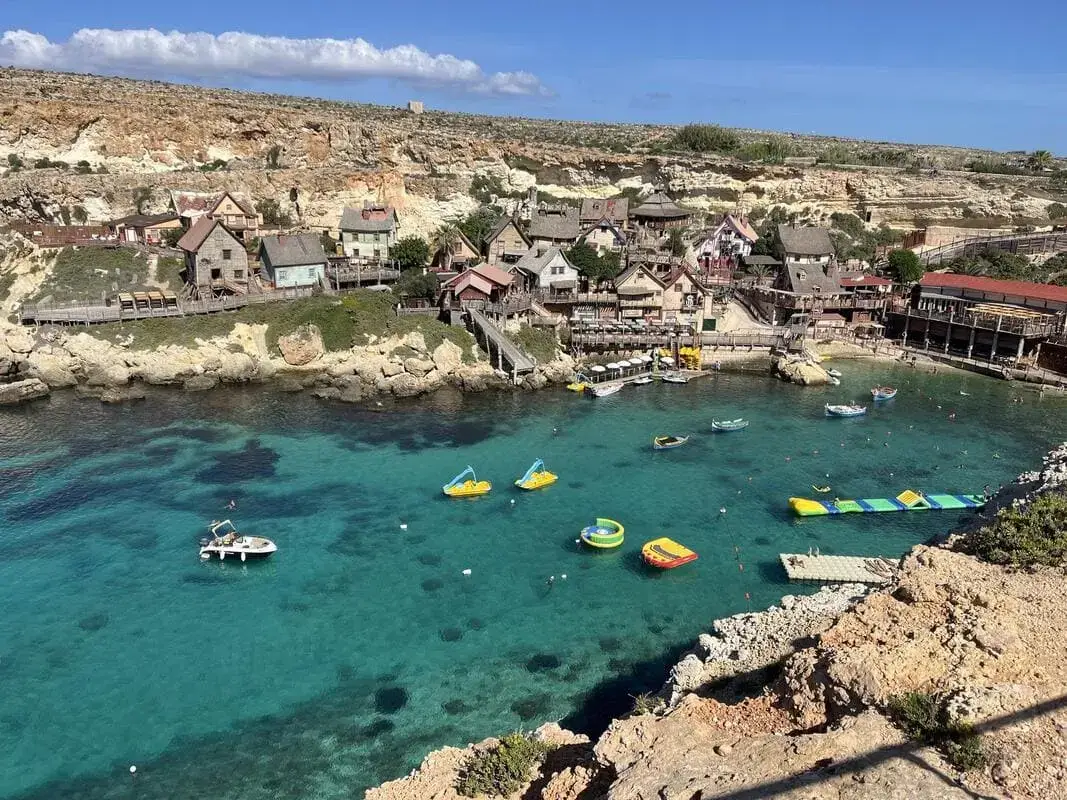 Popeye Village Malta - Vista panoramica Sweethaven Village Anchor Bay Mellieha Vista panoramica del Popeye Village Malta dal punto panoramico sopra Anchor Bay con casette colorate di Sweethaven Village e acqua turchese