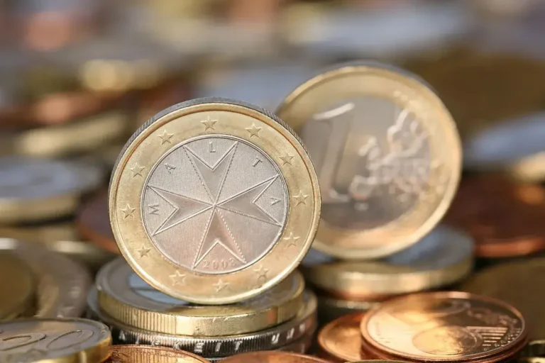 Maltese 1 euro coin showing the Maltese cross design among other euro coins
